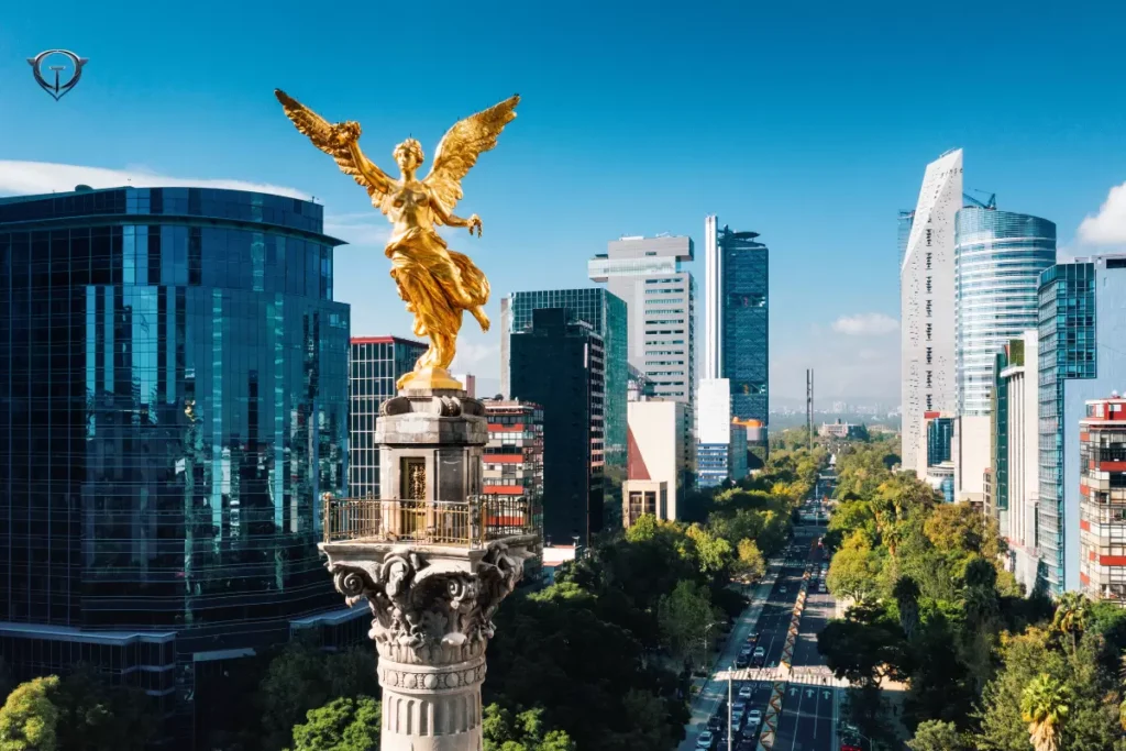 View of Mexico City with tall buildings, busy streets, and green spaces.